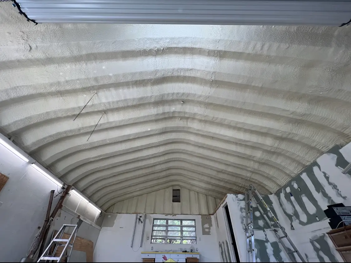 Spray polyurethane foam applied to the underside of a metal roof deck in Orono